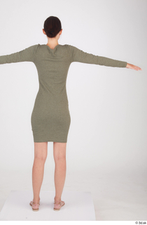 Vanessa Angel dressed green long sleeve dress standing t poses…